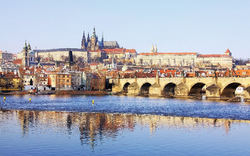 Snowy Prague gothic Castle with Charles Bridge in the sunny Day